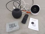 a small speaker and a remote control on a table