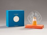 an image of a glass angel figurine next to a blue box