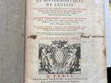a book with a picture of a coat of arms on top of it