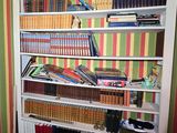 a book shelf with many books on it in a room