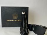 the black boot is next to the box and the black boot is next to the box