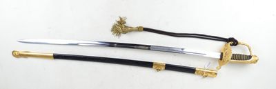 two swords on a white surface with a gold handle