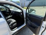 a white car with its door open in a parking lot