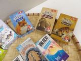 many children ' s books in a basket on a table
