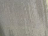 a close up of a shirt with a button on it
