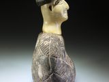 a ceramic figurine of a man with a hat on his head