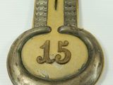 a brass key with the number fifteen on it