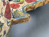 a close up of a decorative piece of art on a table
