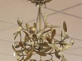 a gold chandelier hanging from the ceiling in a room
