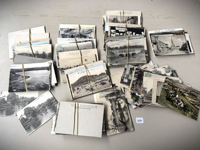 a lot of old black and white photos on the table