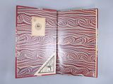 a red and white book with a note inside of it