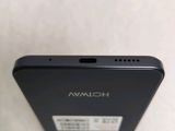 the back of a black cell phone sitting on top of a table