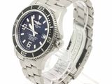 a stainless steel watch with a blue dial on a bracelet