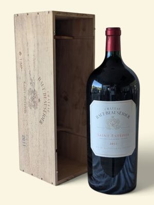 a bottle of wine sitting next to a wooden box