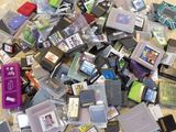 a pile of old video game cartridges on the floor