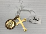 un gros plan sur une croix et une médaille en or suspendue à un cordon