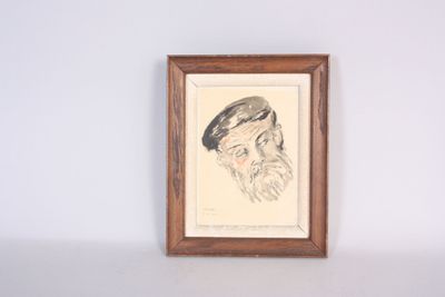 an old picture of a man with a beard and a hat is hanging on a wall