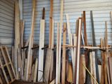 a lot of wooden boards and paddles in a storage area