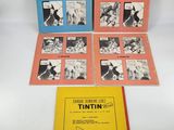 three books of tintin with pictures of dogs and cats on them