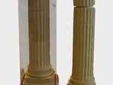 a small statue of a man standing next to a tall pillar
