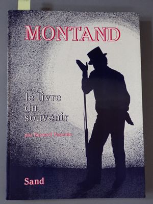 un livre sur lequel figure l'image d'un homme portant un haut-de-forme et tenant une canne