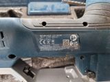 a close up of a blue electric tool on a table