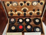 a wooden box with a bunch of old records inside of it