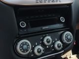 a car dashboard with a radio and a remote control