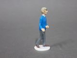 a figurine of a man in a blue sweater and brown shoes