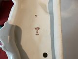 a white porcelain sink sitting on top of a table