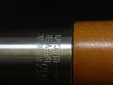 a close up of a pen with a wooden barrel