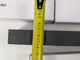 a measuring tape that is attached to a piece of metal