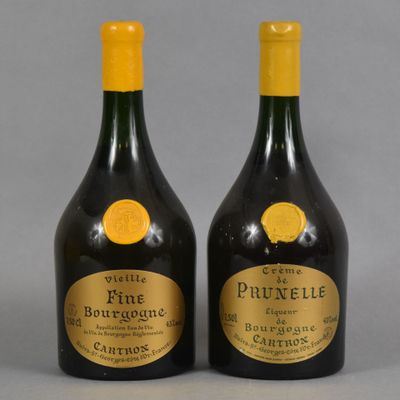 two bottles of wine with labels on them sitting next to each other