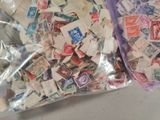 a bag of stamps sitting on a table next to a pair of scissors
