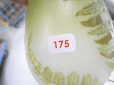 a vase with a sticker on it sitting on a table