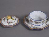 two cups and saucers sitting on a table