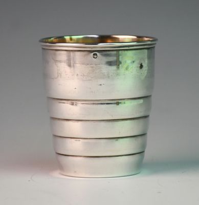 a silver cup that is sitting on a table