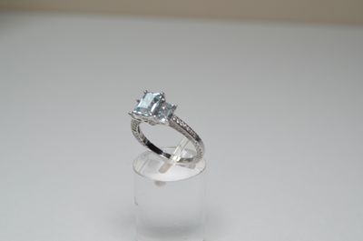an image of a diamond ring on a clear ring holder