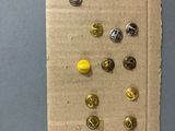 a piece of cardboard with buttons on it on a table