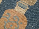 a close up of a rug with a bottle of liquor on it