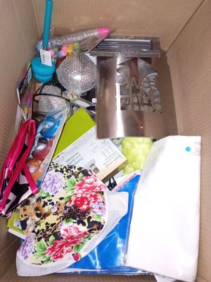 a cardboard box filled with assorted items and a toothbrush