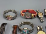 many different types of watches and bracelets laid out on a table