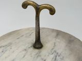 a close up of a metal object on a marble surface