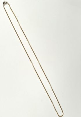 a close up of a necklace on a white surface with a white background