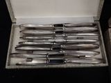 six pens in a box on a black surface