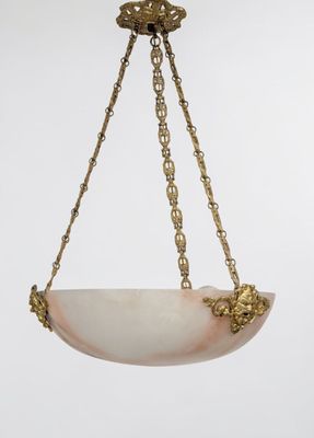 a gold plated chandelier with a white marble bowl hanging from the ceiling