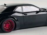 black dodge charger with red rims on a white background