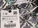 an image of a label on a dress with a floral pattern