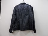 black leather jacket hanging on a white wall in a room