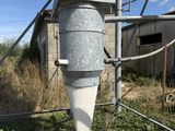 a large metal funnel sitting on top of a metal pole